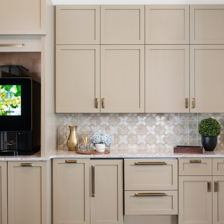 Beige cabinets, granite countertops, and a coffee maker